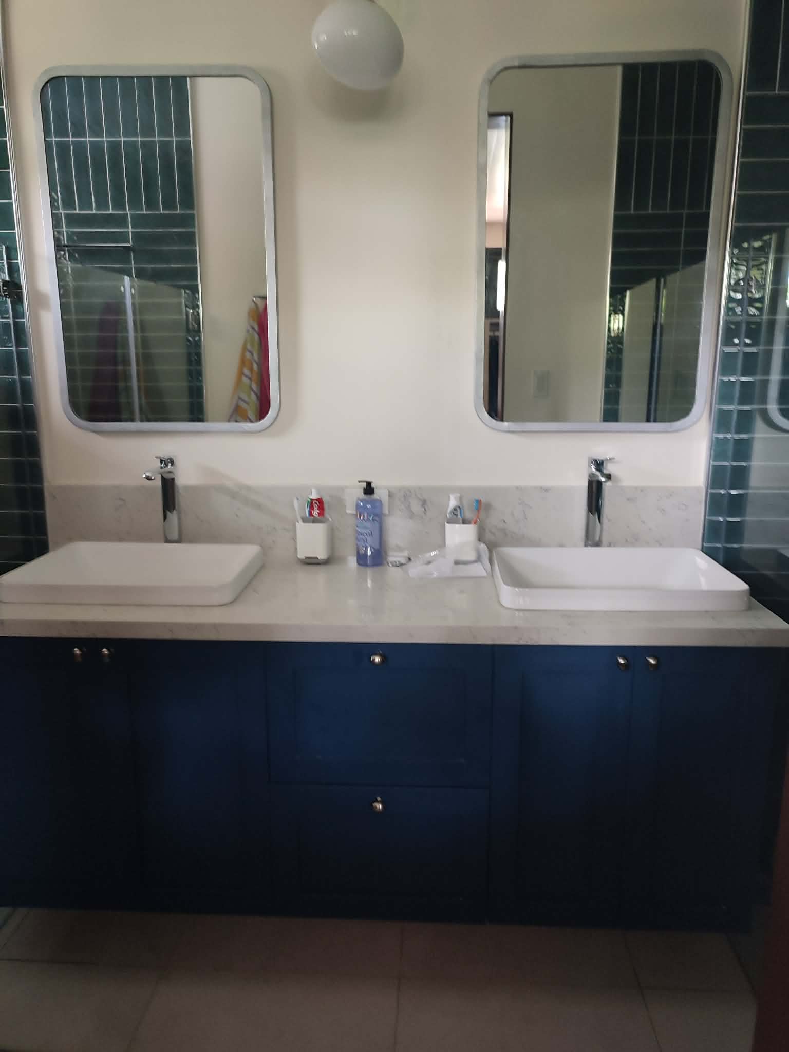 Blue kitchen with white backsplash