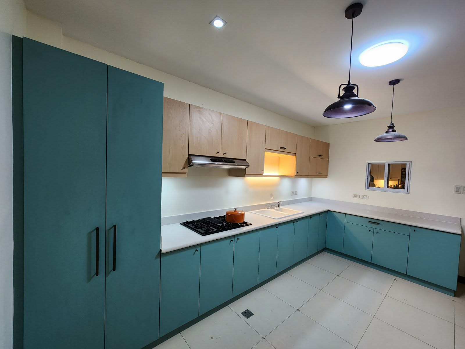Blue kitchen with white backsplash